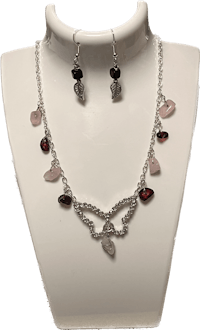a necklace and earring set with pink stones