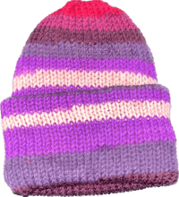 a purple and pink knitted beanie on a black background